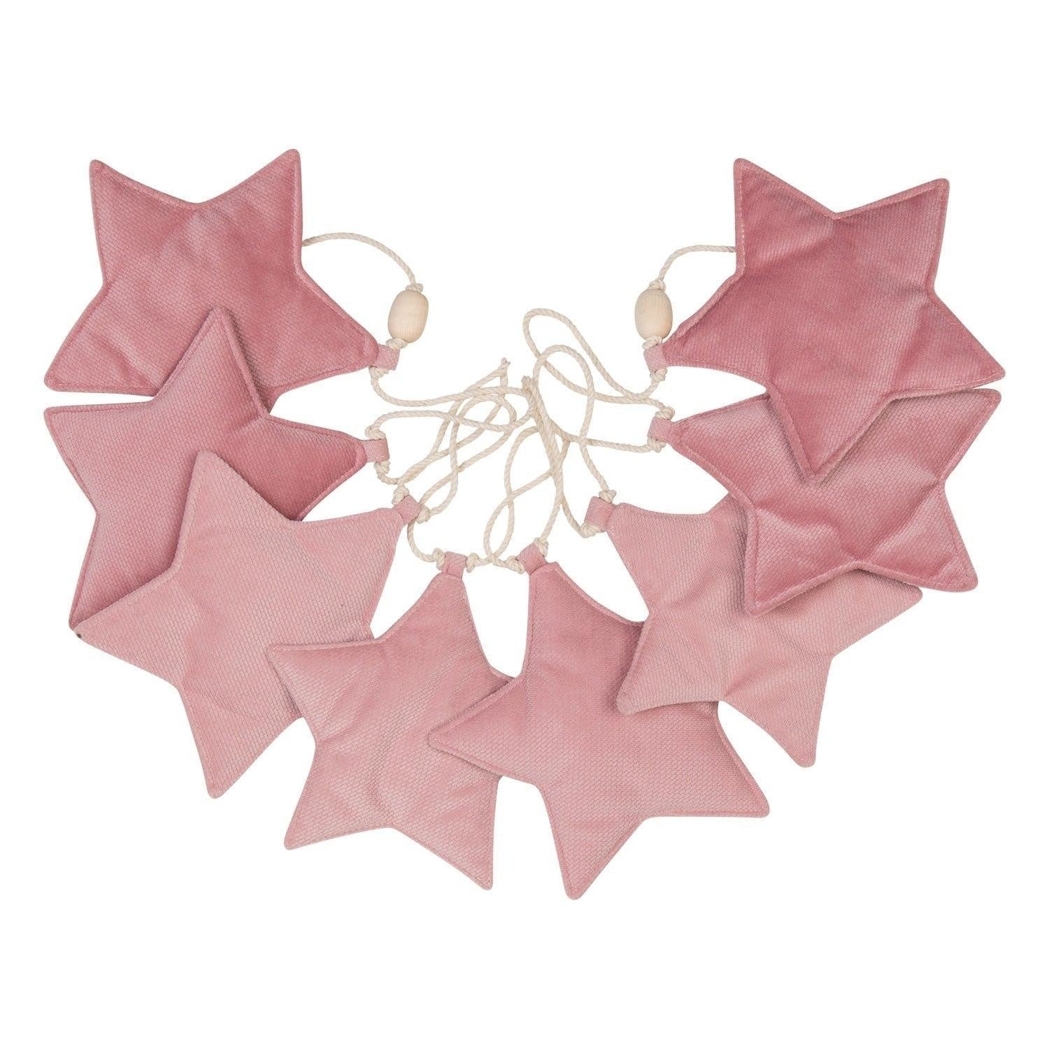 close-up of soft pink velvet star garland with wooden beads on a playful cotton string
