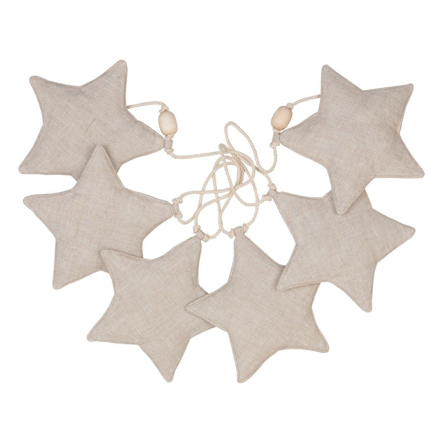 close-up of a sand-dusted linen star garland with wooden beads, hung on a natural cotton string