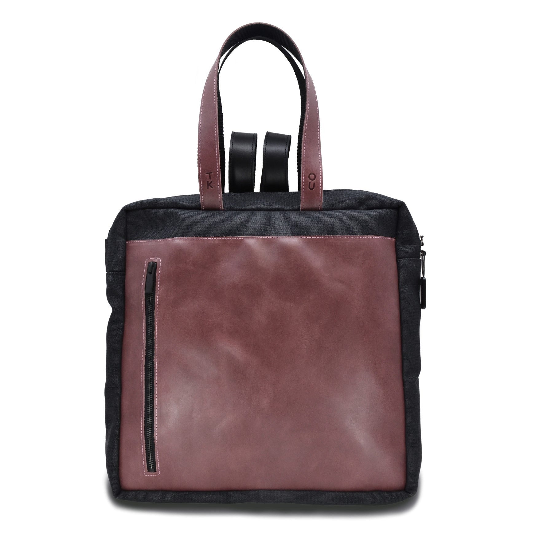softly lit purple and black stockholm backpack with elegant leather details on a cozy background
