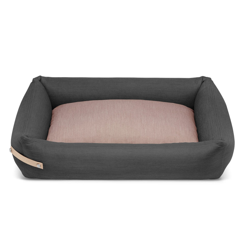 soft grey and pink stokke dog bed with plush filling in cozy morning light