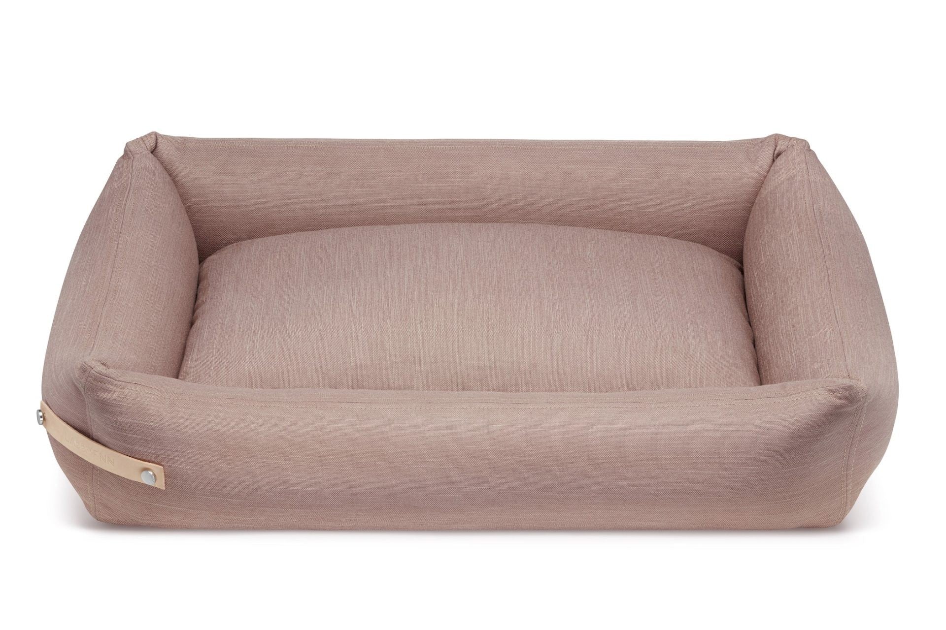 soft pink stokke dog bed with a plush cotton interior in warm morning light