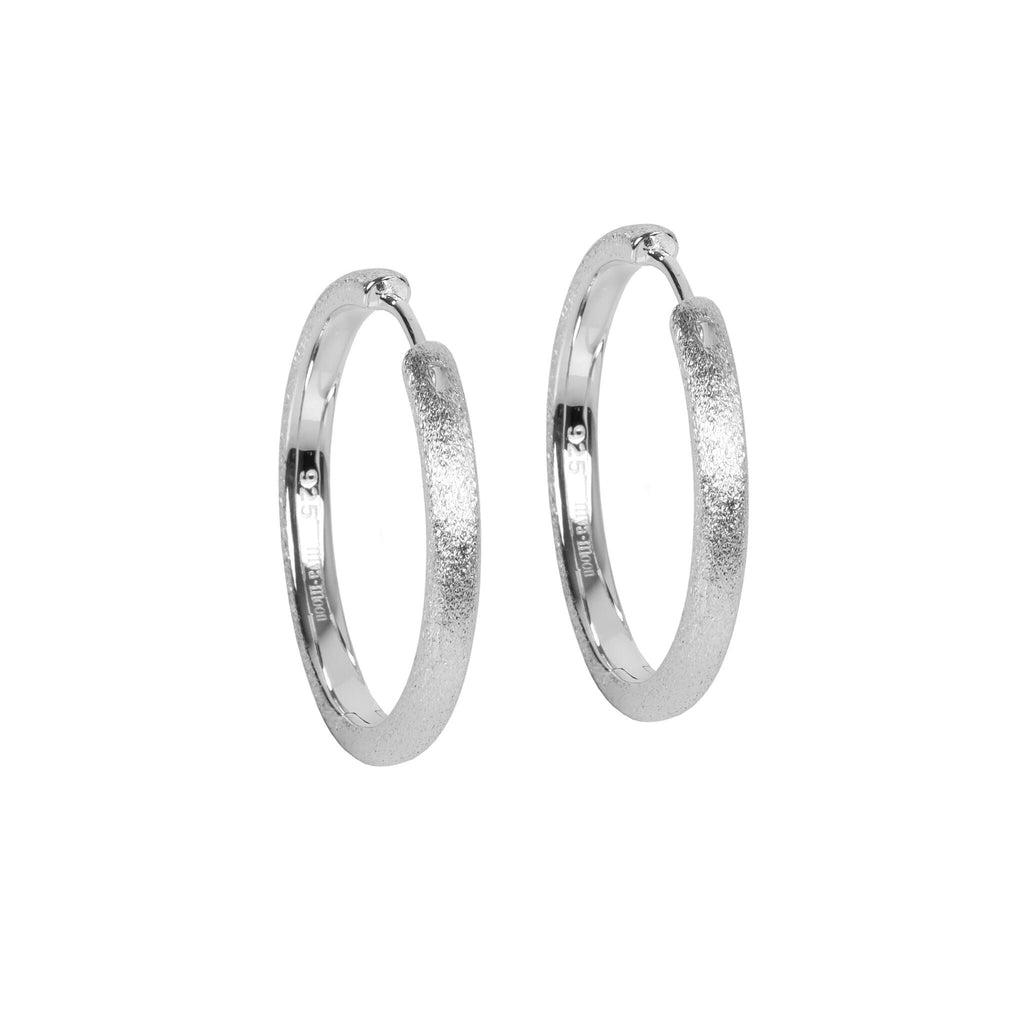 bold close-up of 30mm rose gold sugar hoops l earrings with a brushed-sugar finish and polished interior