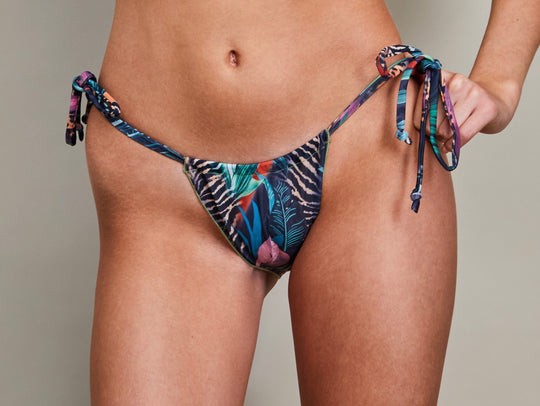 softly lit tan-through seashell bikini top on a sandy beach, offering a gentle and comfortable fit