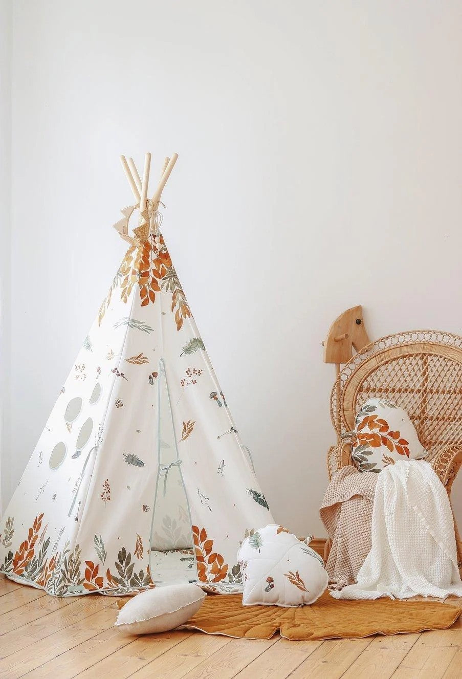 a playful peek inside the forest friends teepee tent with a child's book resting in the inner pocket