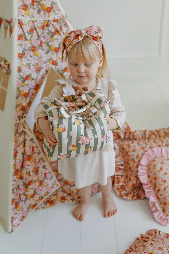 green garden teepee tent with floral print, pine poles, and inner pocket, set up in a sunlit playroom corner