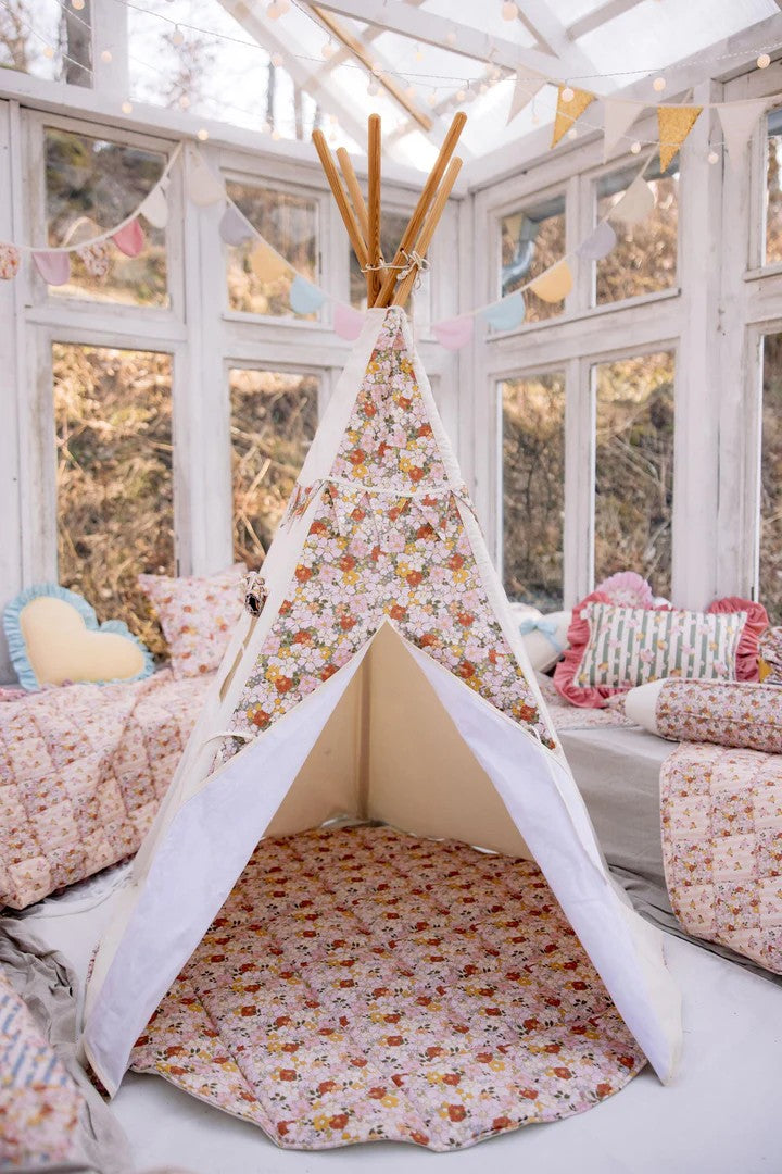green garden teepee tent with soft floral print, open window curtain, and pine poles in a sunlit playroom