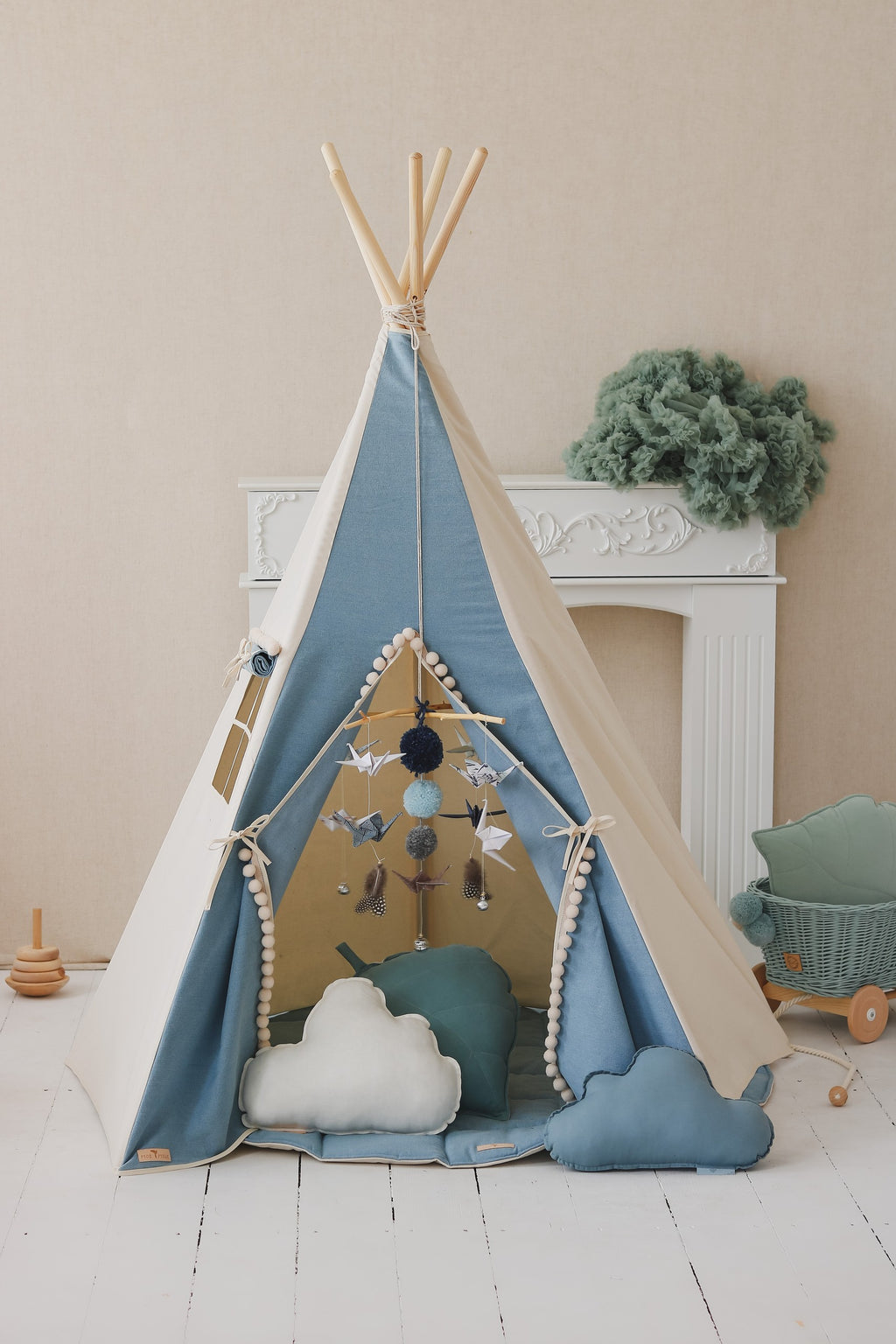 bold adventure teepee tent with playful pompoms in a sunlit playroom setting