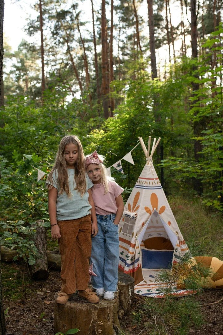 bold geometric teepee tent with pine poles, bathed in golden sunset light for adventurous indoor play