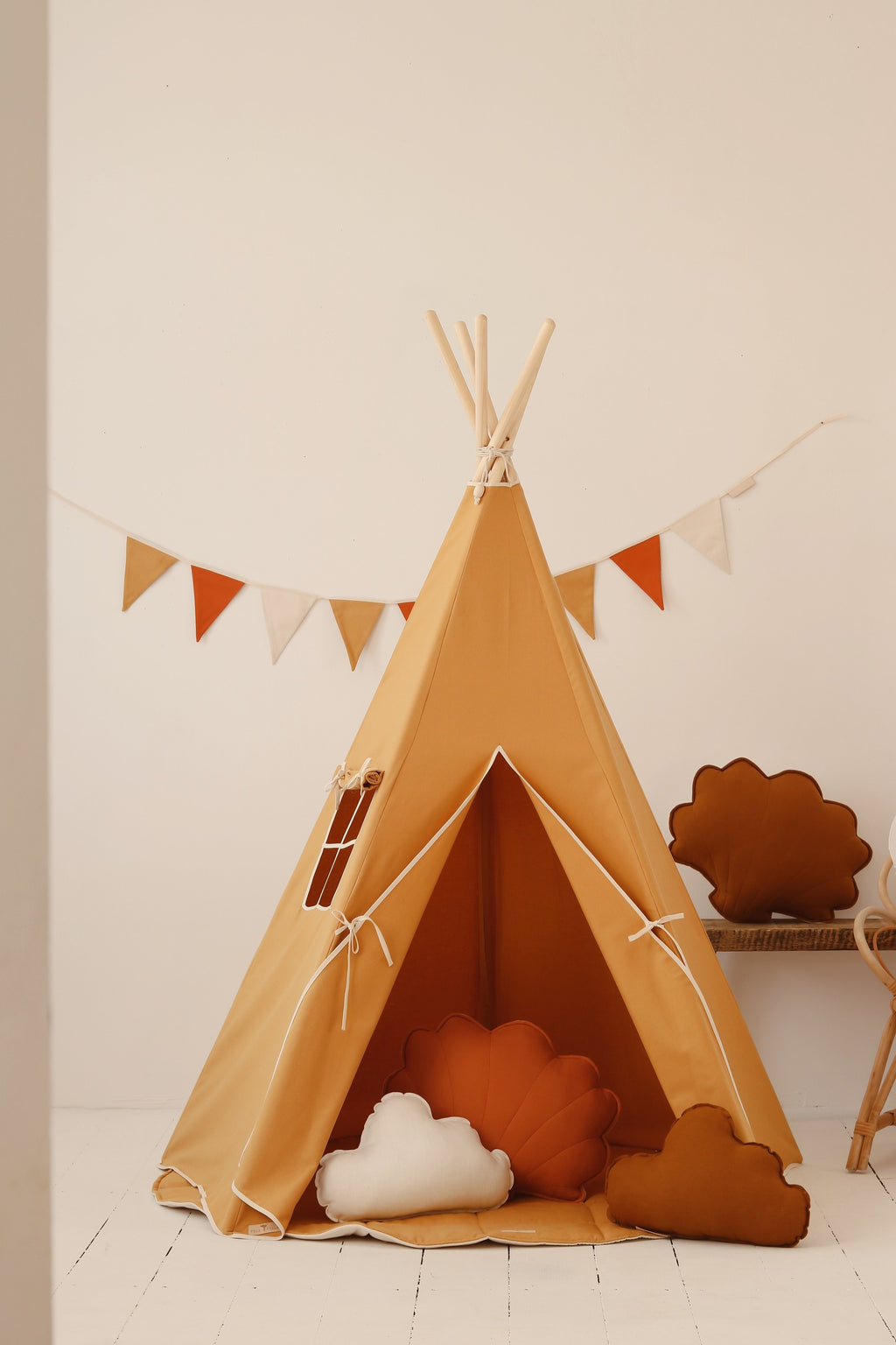 kids laughing and playing peek-a-boo from inside the vibrant orange handmade teepee tent