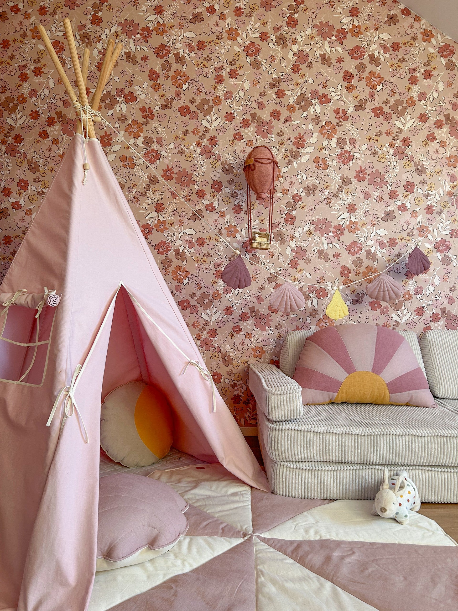 bold front view of a spacious pink kids teepee tent with sturdy pine poles in a bright playroom