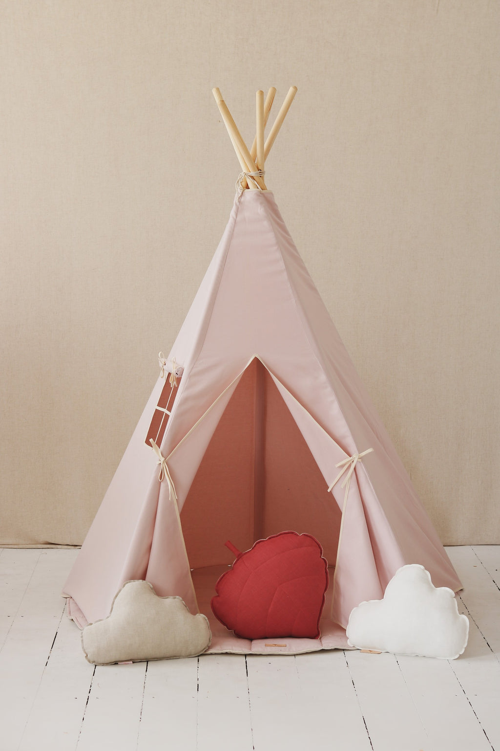 pink kids teepee tent with sturdy pine poles and cotton fabric shown in a bright playroom setting