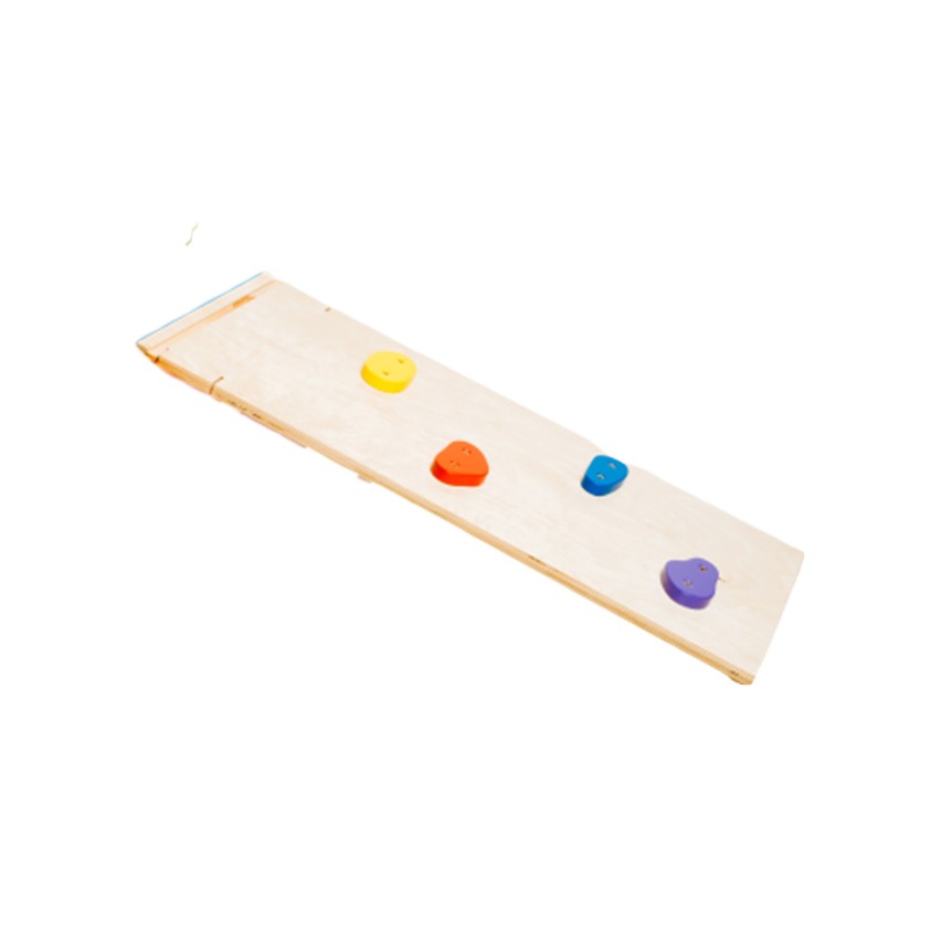 close-up of a toddler's hands gripping the colorful birch plywood rainbow ramp's climbing rocks