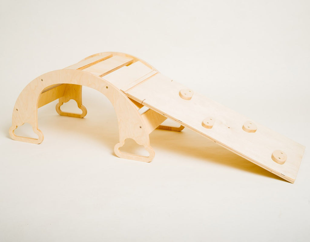 elegant birch plywood rainbow ramp with climbing rocks in a refined nursery setting