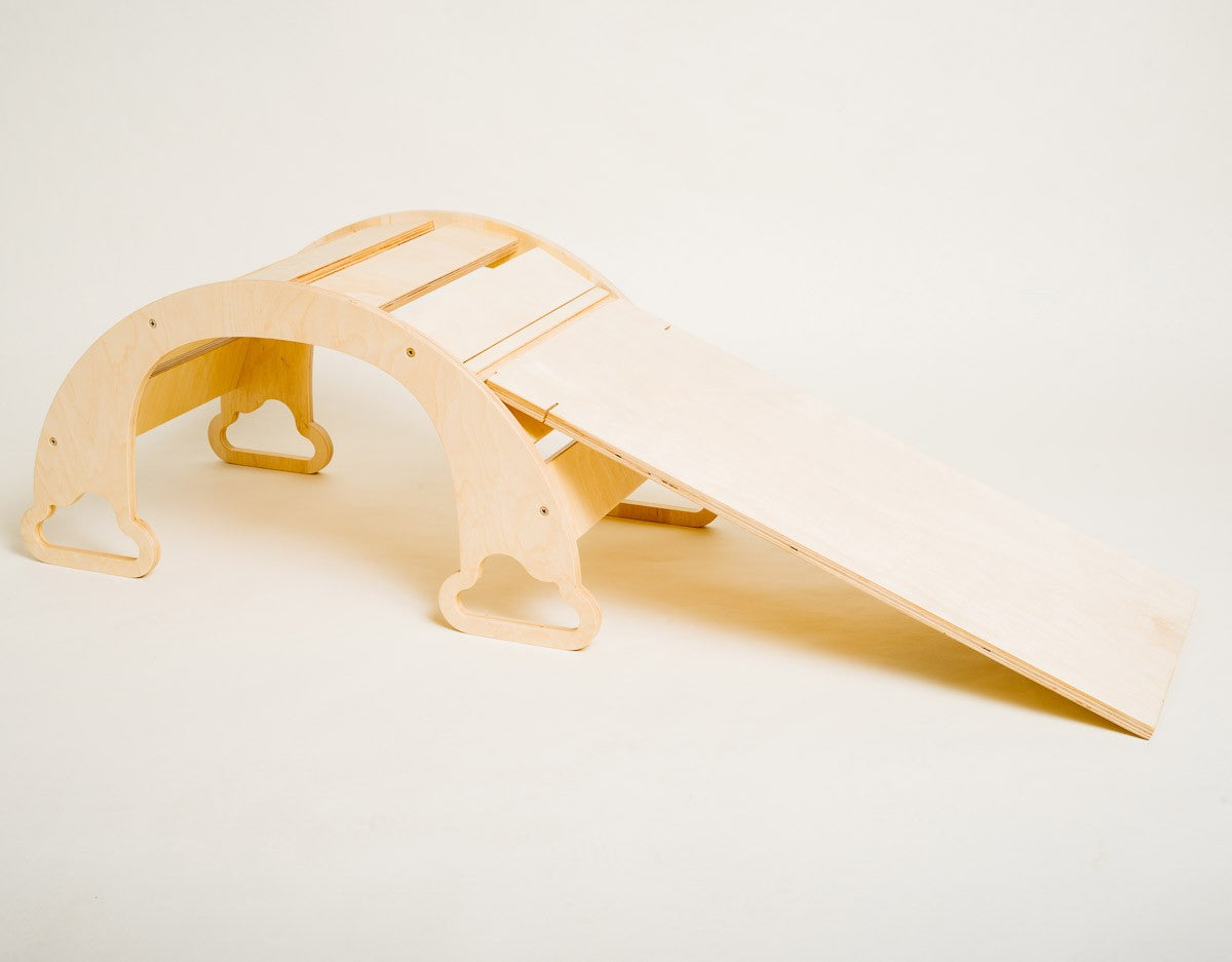 rainbow ramp with four climbing rocks attached on the textured side for toddler motor skill development