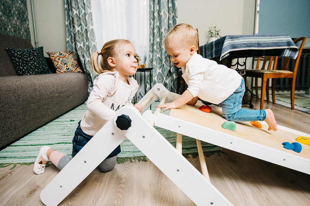 confident toddler climbing the sturdy birch pikler triangle in a sunlit playroom