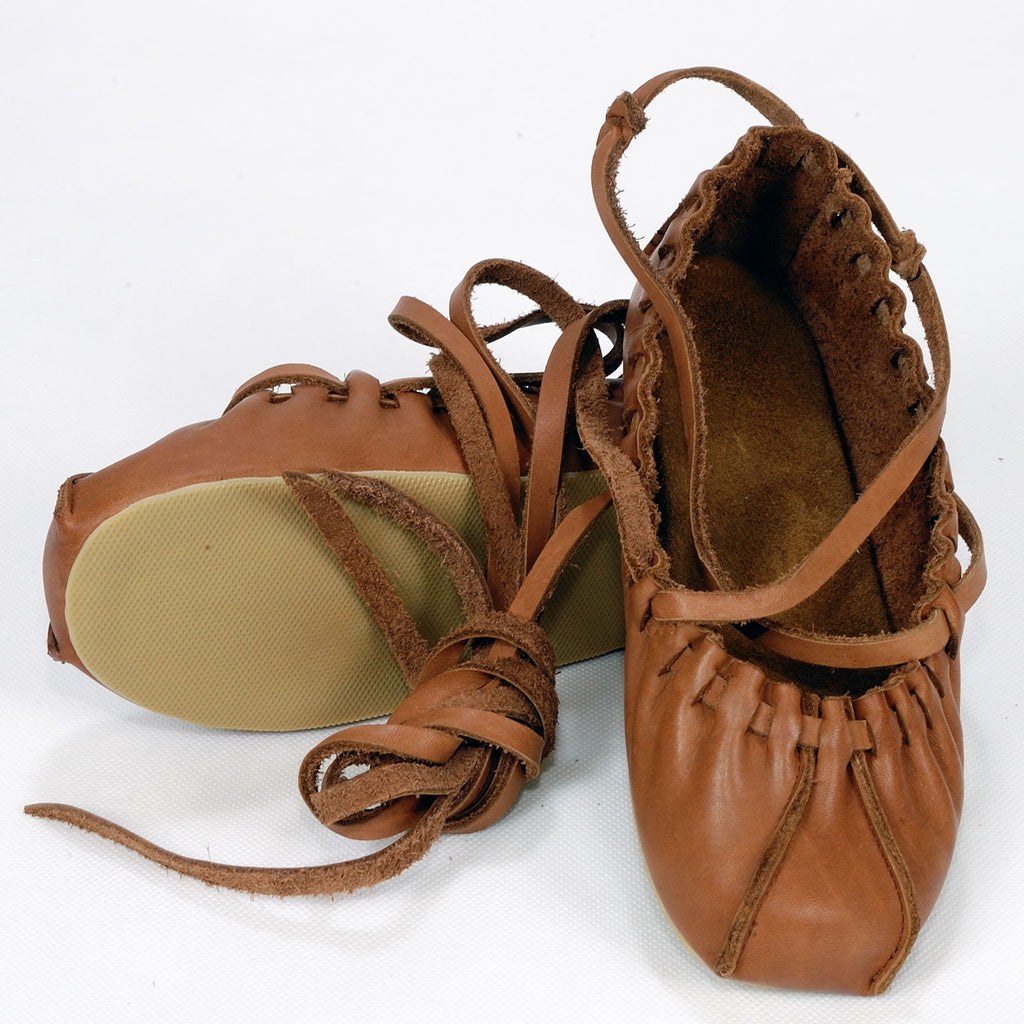 playful tied dancing shoes mid-twirl, showcasing soft leather and adjustable laces on a sunny studio floor