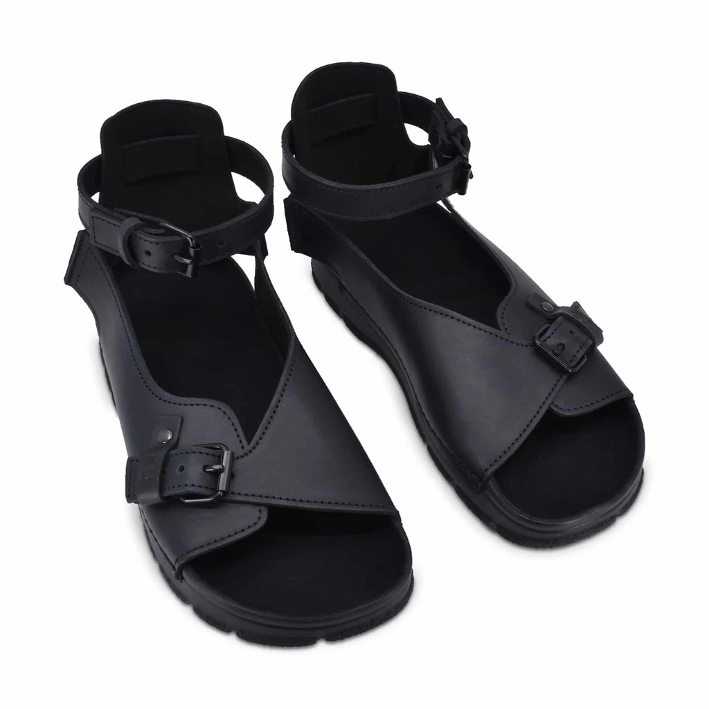 close-up of toku athens black leather sandal showing the supportive cushioned insole and durable pu outsole