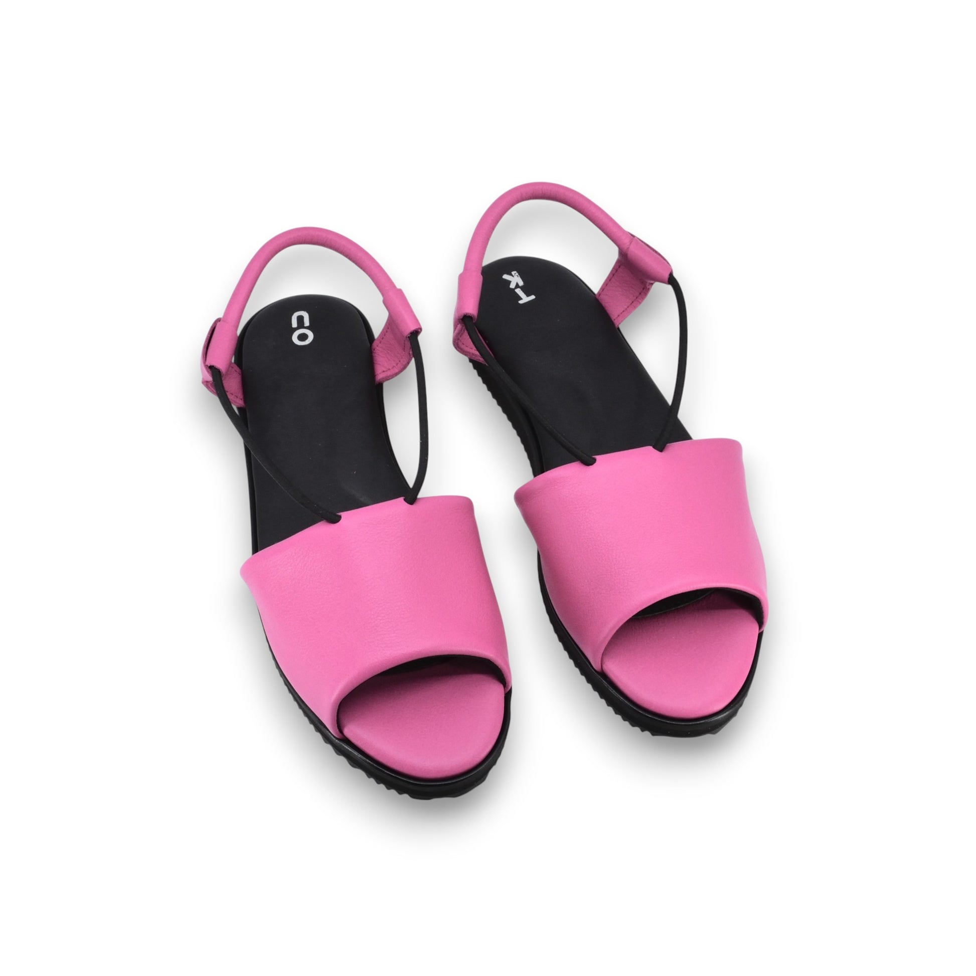 bold fuchsia toku berlin sandals on a dark concrete background, showcasing the vibrant leather and artisan craftsmanship