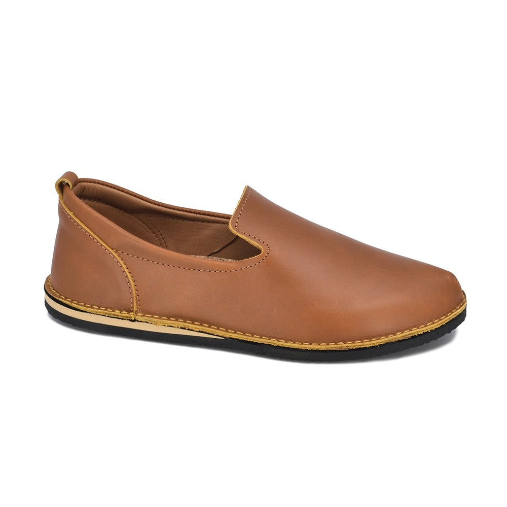 playful ocre leather loafers on a sunny walk, showing flexible sole and natural cork comfort
