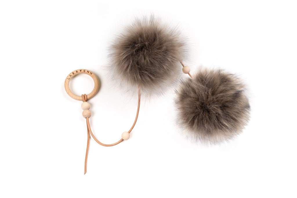 a soft anthracite cat toy with a gentle drape, showcasing its handmade leather and cozy faux fur balls