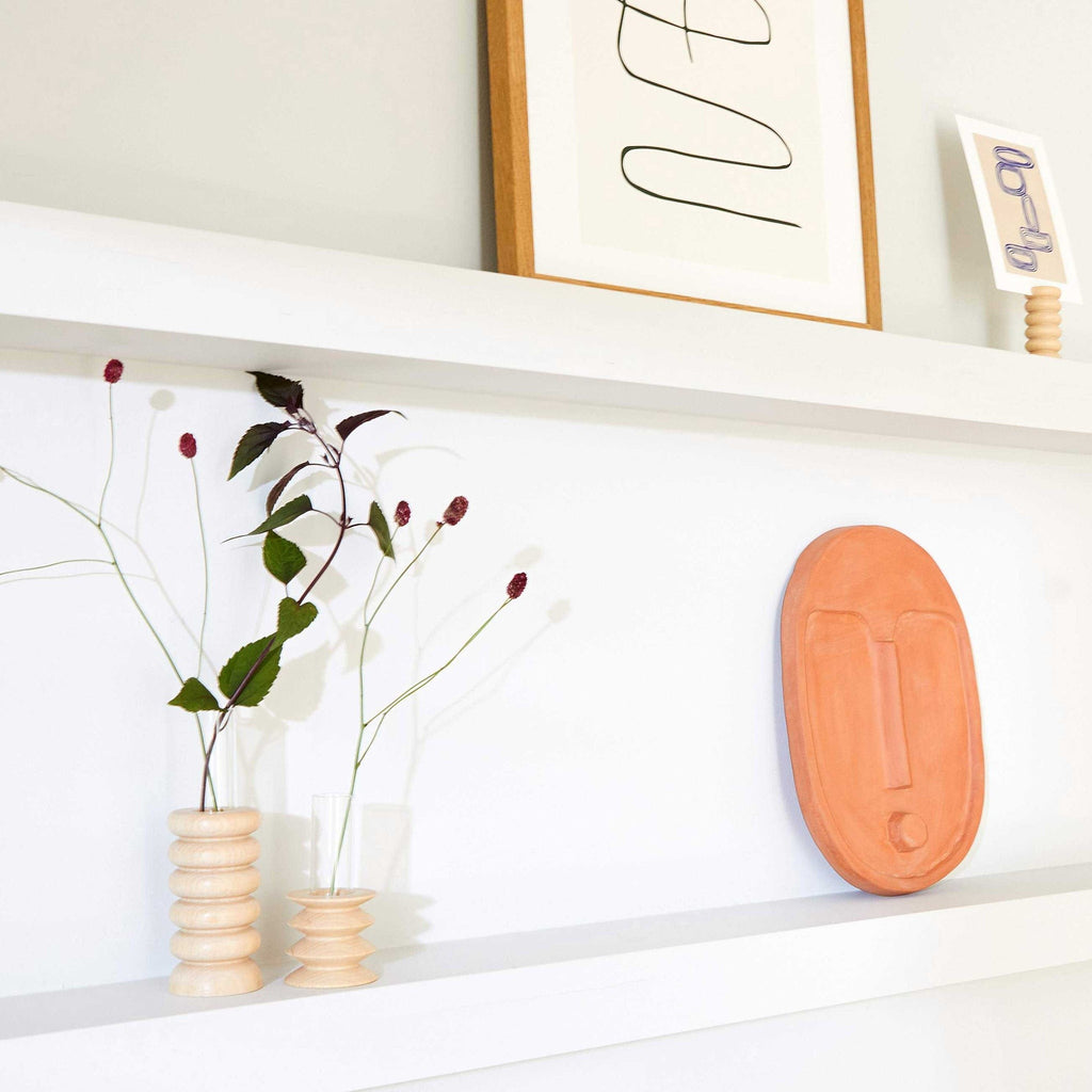 elegant wooden totem vase on a rustic table with soft morning light highlighting its grain