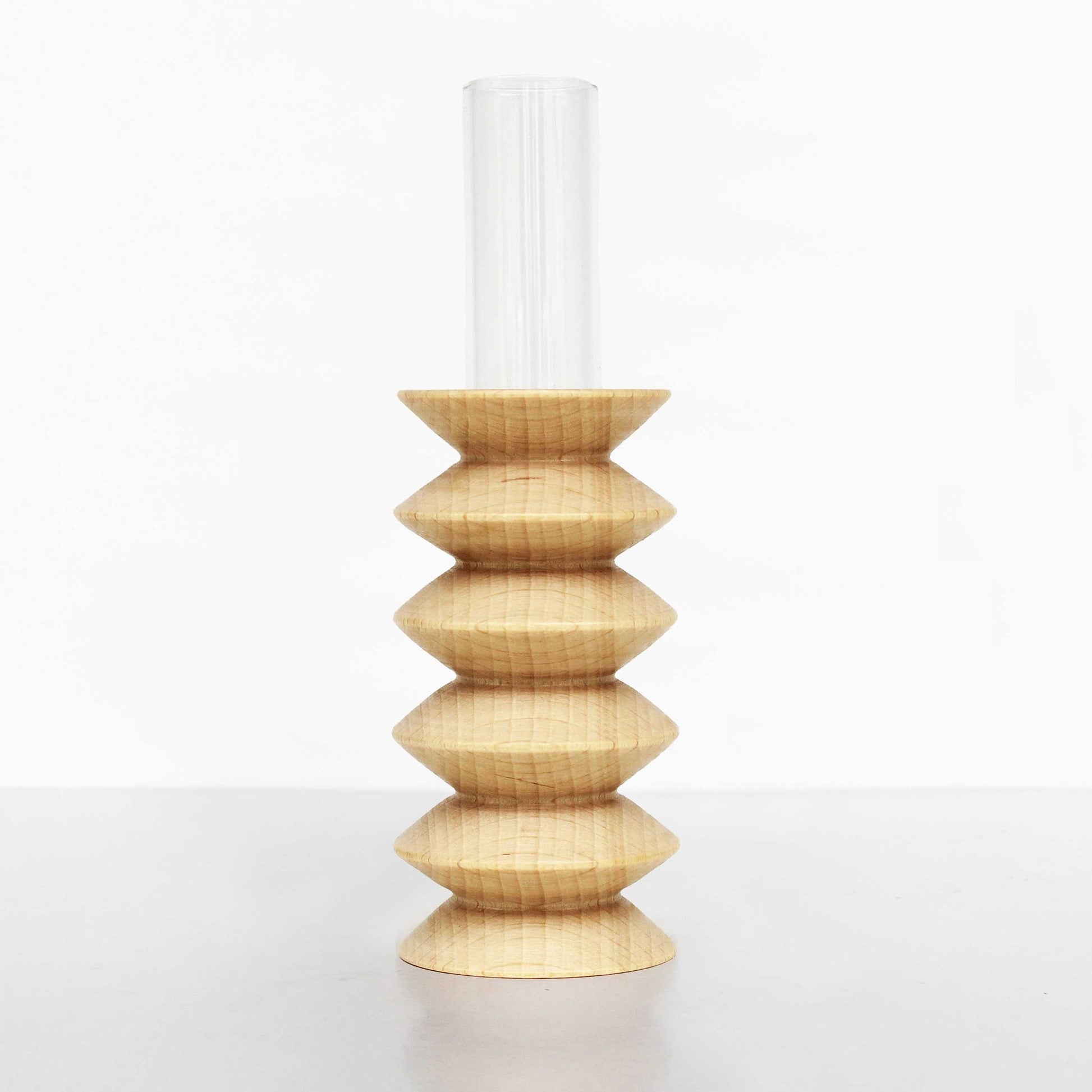 playful beech wood totem vase on a sunlit windowsill with a single cheerful flower