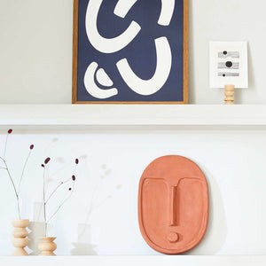 elegant beech wood totem vase with glass insert on a minimalist table