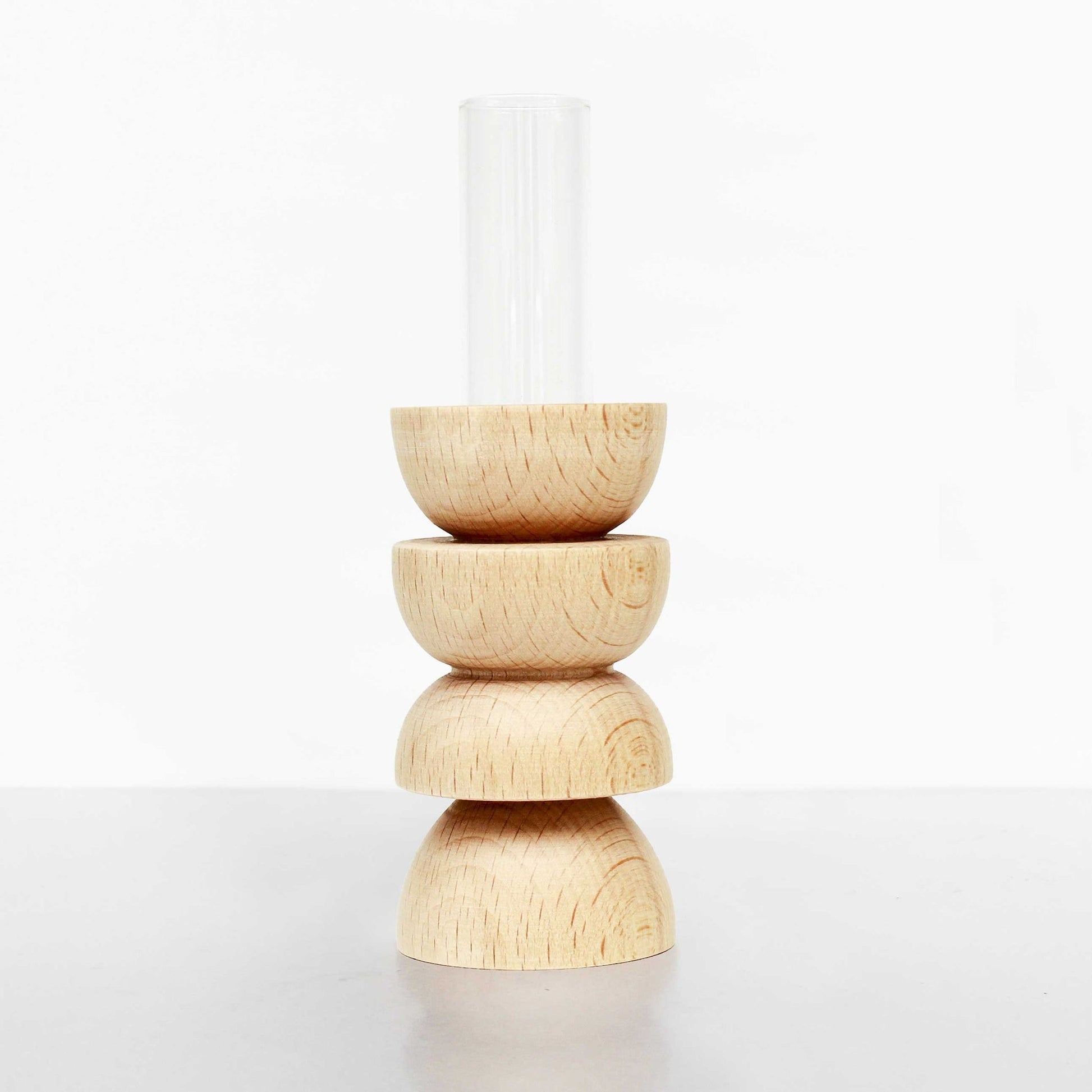 playful modern totem vase with a single bright flower in a sunlit room