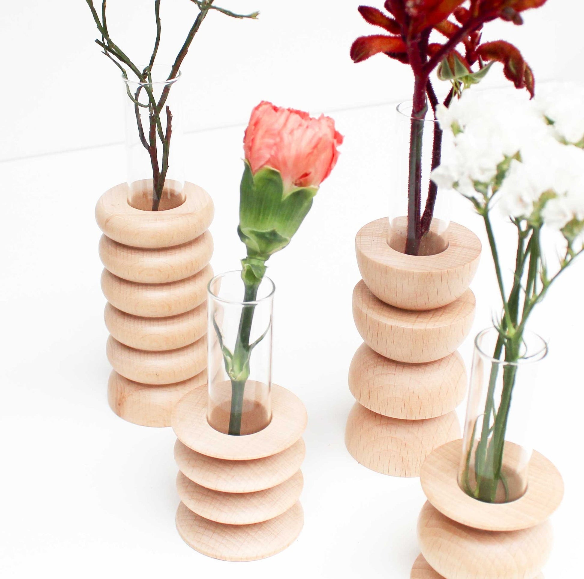 elegant beech wood vase with glass tube on a minimalist marble surface