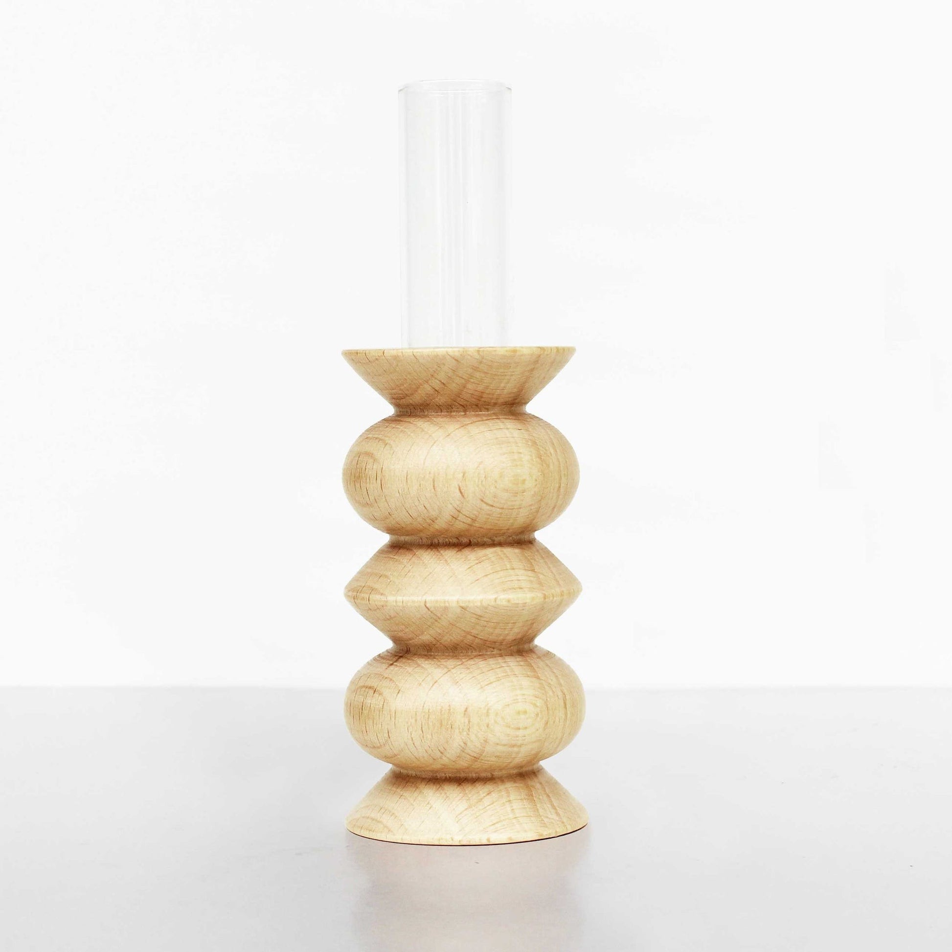 a soft-lit beech wood totem vase with a glass insert on a cozy home shelf