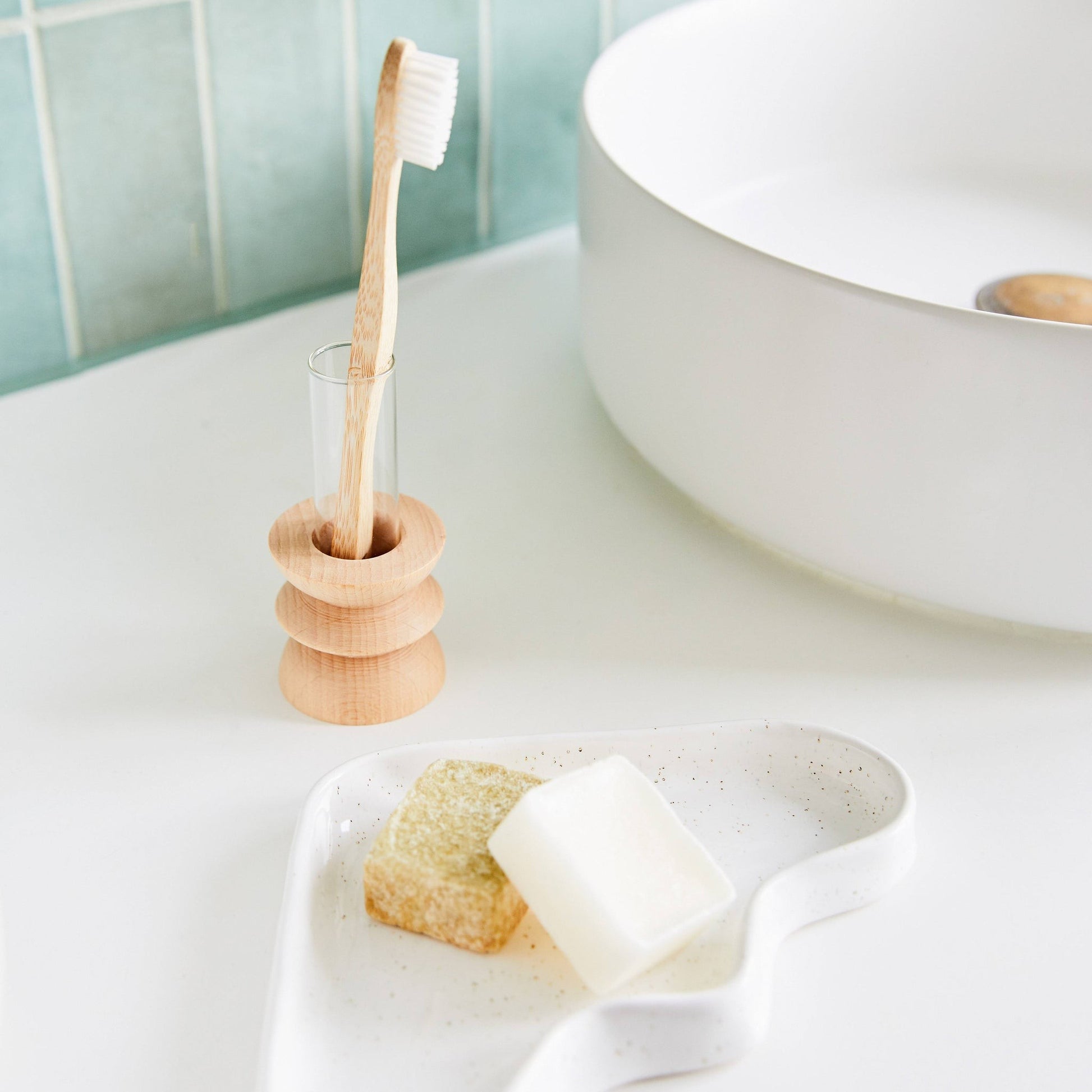 playful beech wood totem vase with a single vibrant wildflower on a sunlit windowsill