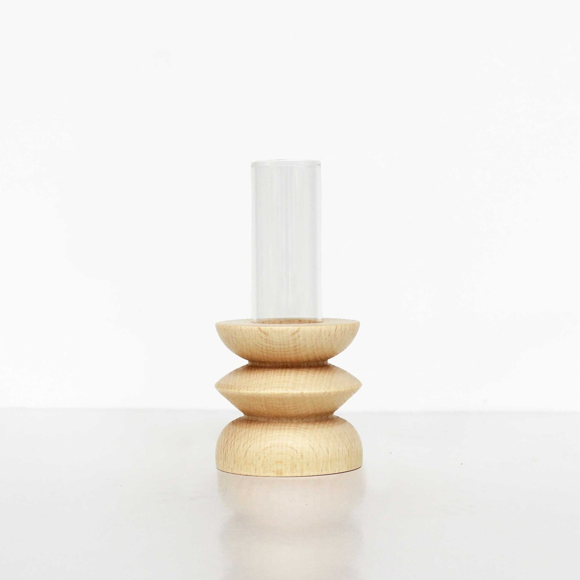 softly lit beech wood vase with glass tube on a cozy table