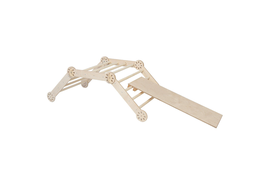 a joyful toddler climbing the montessori climber in a sunlit playroom