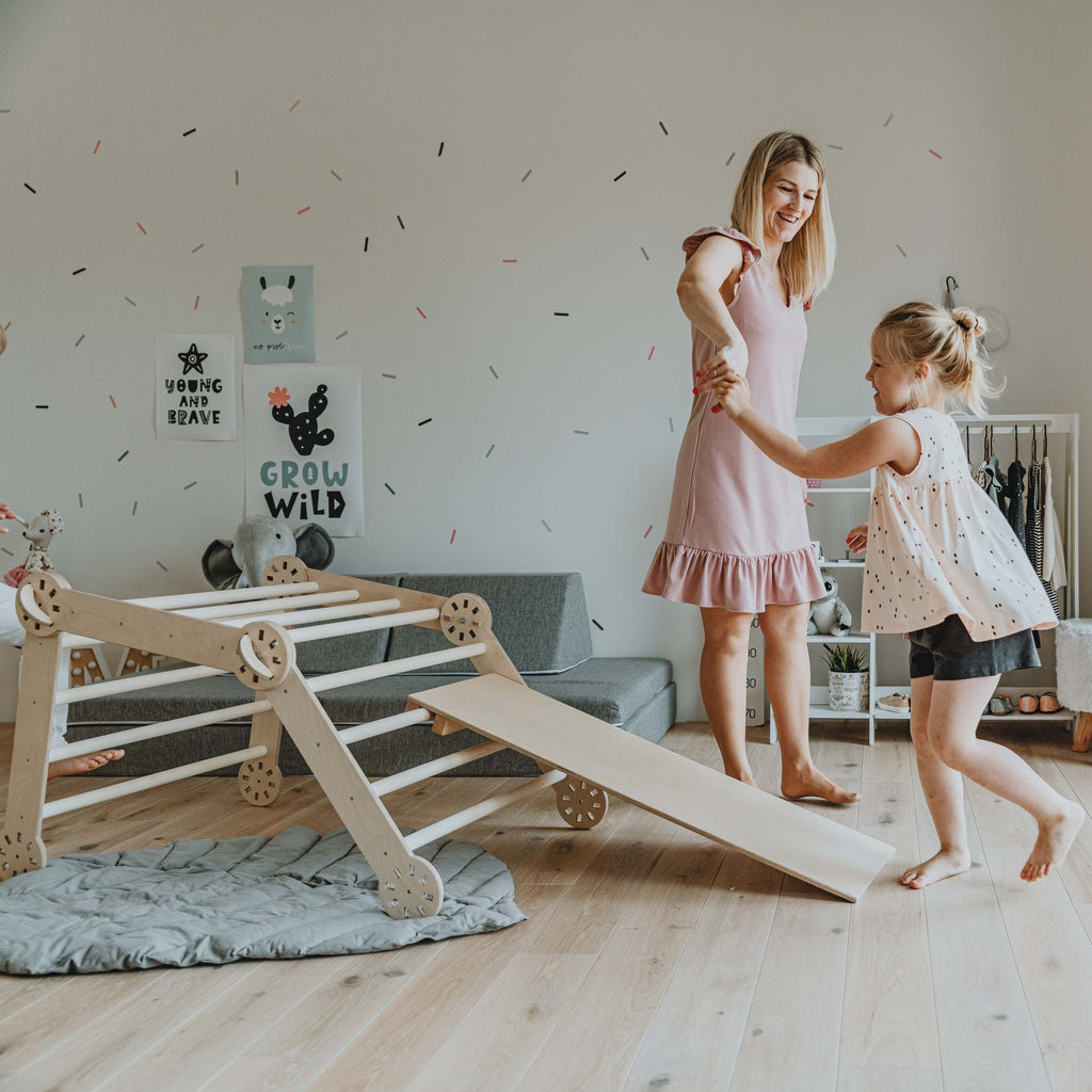 confident toddler climbing the montessori climber's birch plywood ramp
