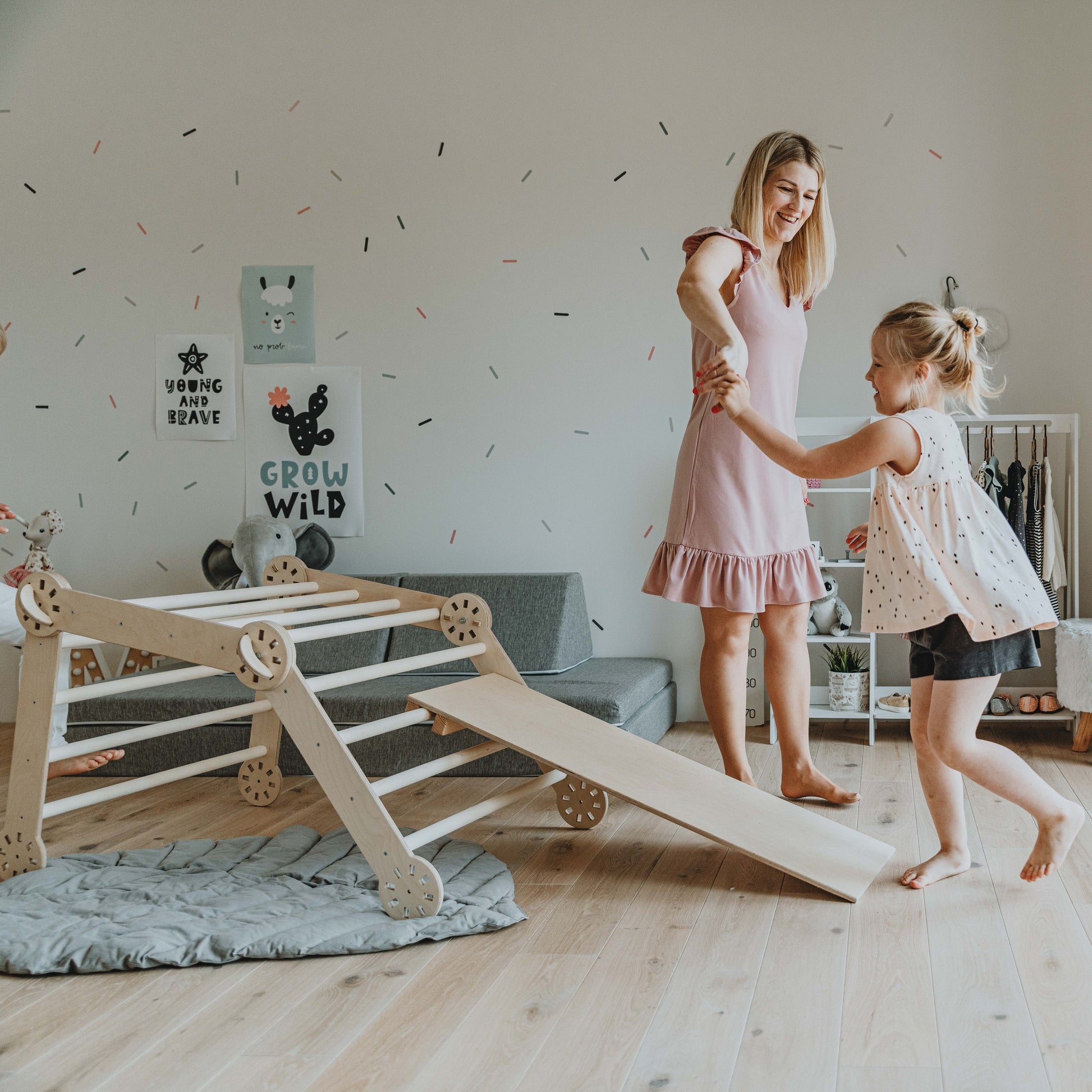 confident toddler climbing the montessori climber's birch plywood ramp
