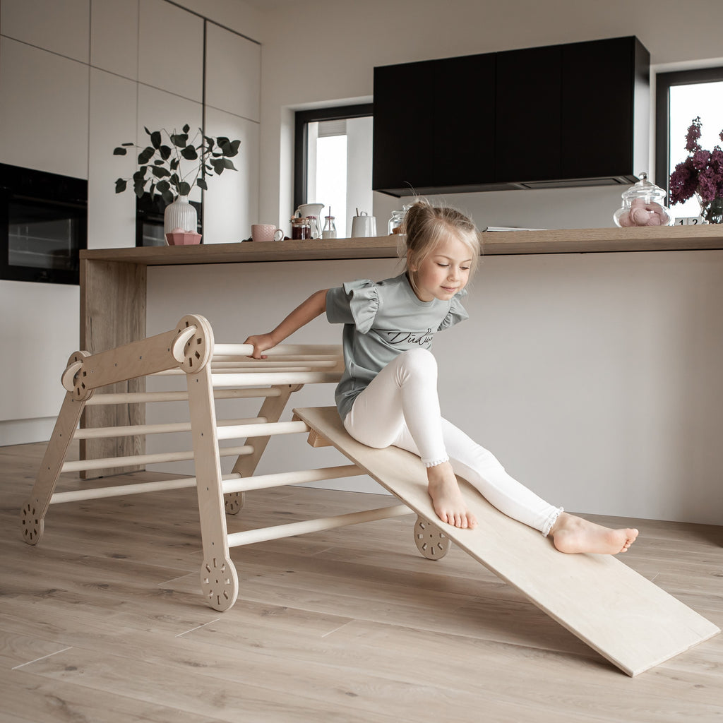 a gentle side view of the montessori climber showing its smooth birch wood grain and soft, inviting angles