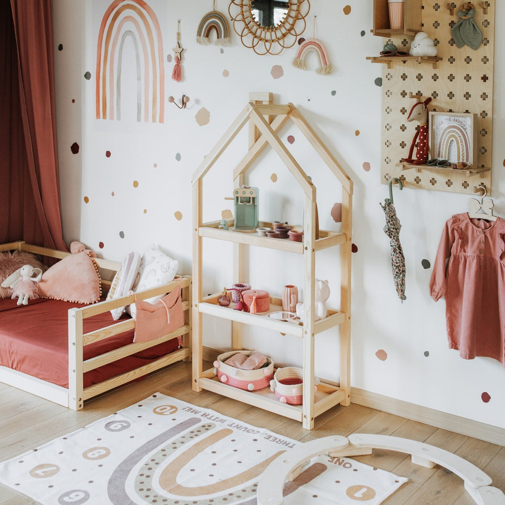 white house-shaped kids shelf with toys in soft morning light, blending play and storage