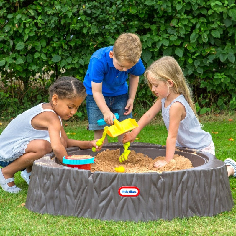 confident view of a whimsical tree trunk sandbox with cover, ready for backyard adventure