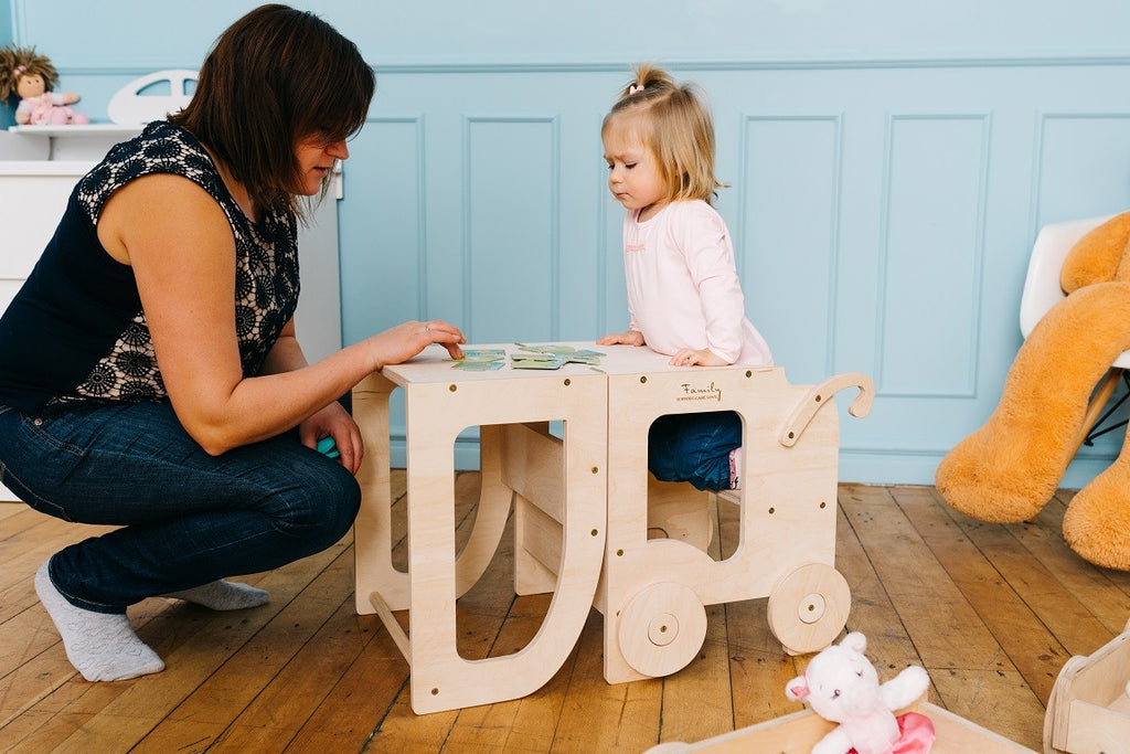 a child using the convertible montessori helper in table mode for a focused snack time