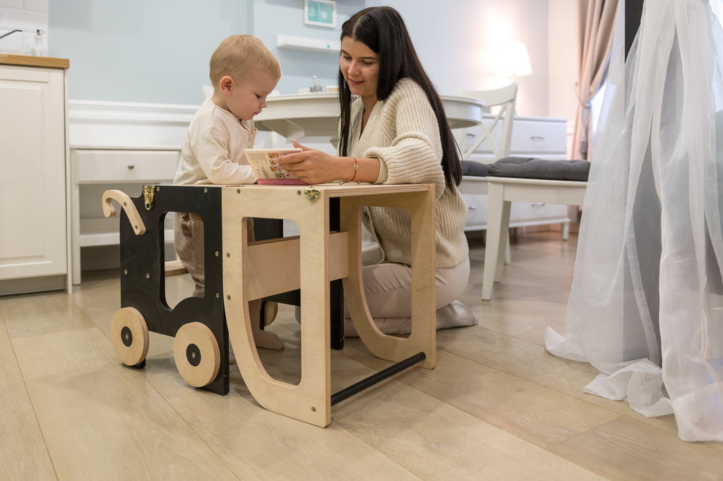 a child in a golden yellow kitchen helper table reaching for a cookie jar on the counter