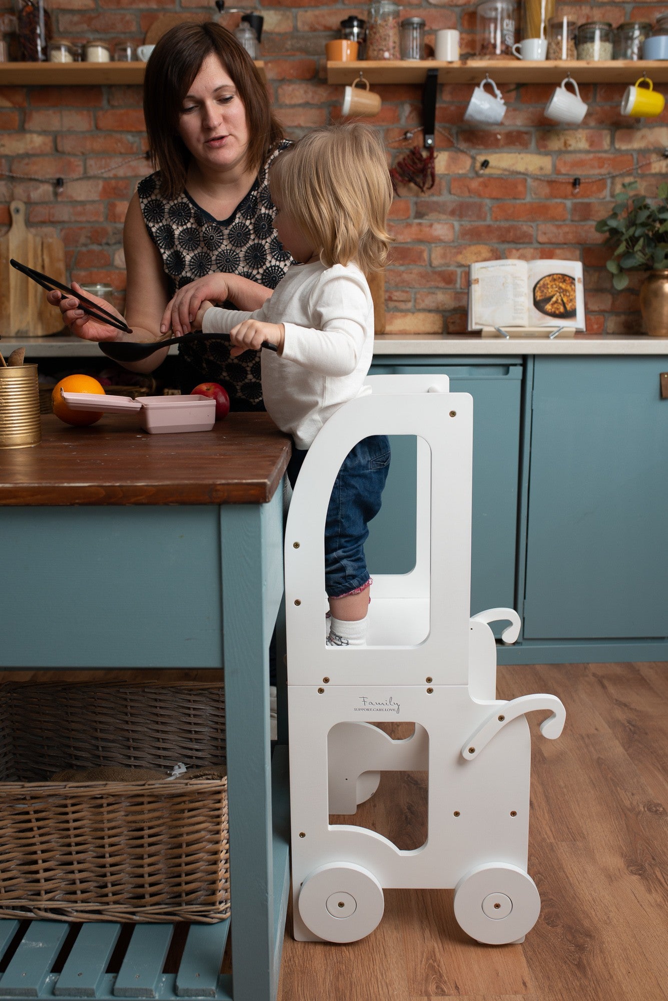 a child in a soft cotton outfit stands at the warm yellow montessori table, bathed in gentle morning light