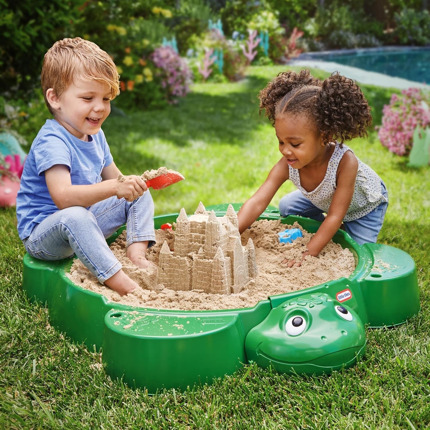 turtle sandbox with cover closed showing practical storage in a sunny garden