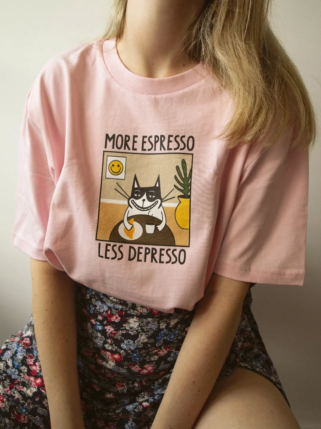 confident model wearing a bold more espresso less depresso unisex tee in a well-lit urban setting