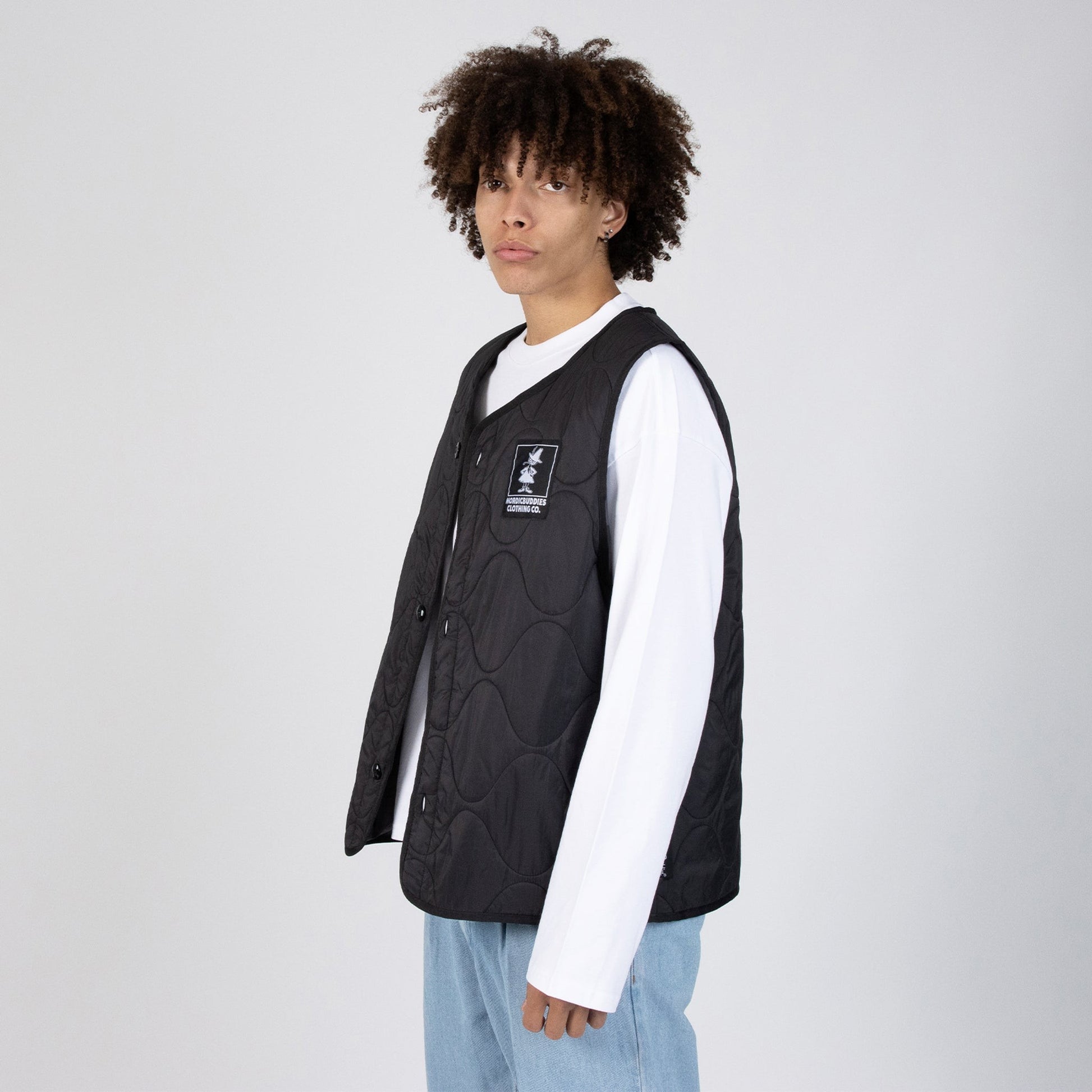 snufkin fishing vest in soft morning light, a comforting black nylon layer for quiet outdoor moments