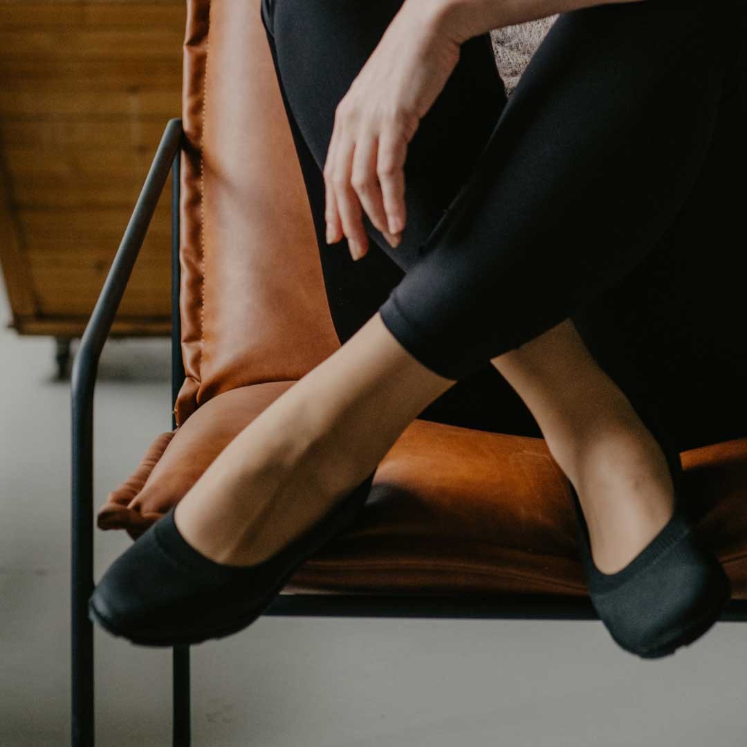 elegant upcycled ballerina shoes with recycled tyre soles, soft tencel lining, and sleek italian design on a marble floor