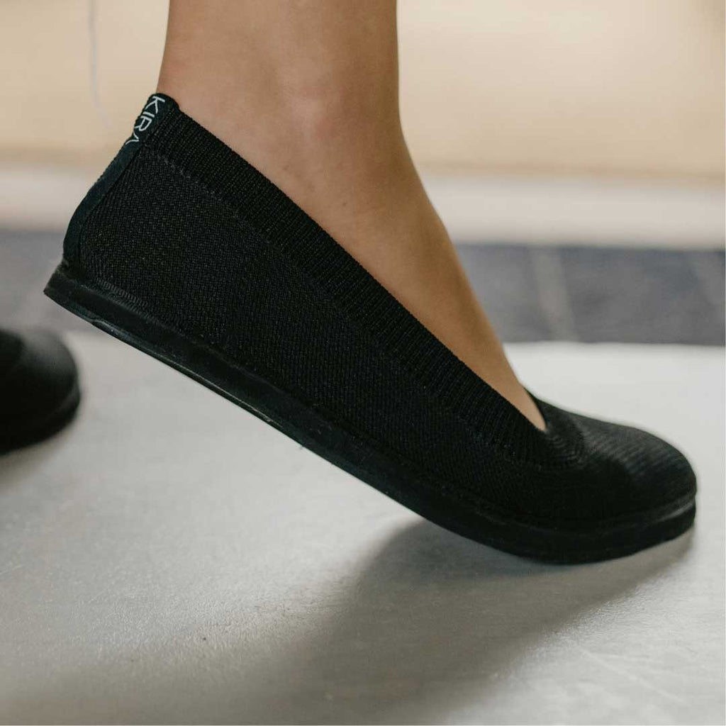 close-up of upcycled ballerina shoes with recycled tyre soles, soft tencel lining, and stretchy knit upper in natural light