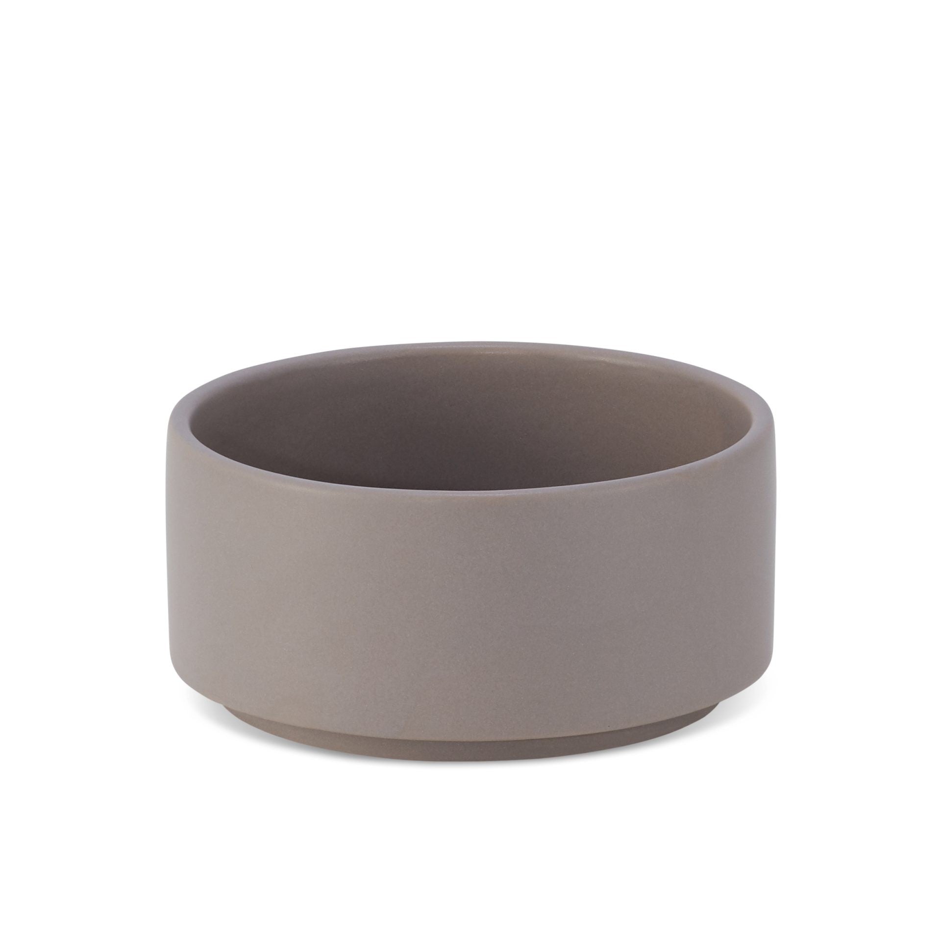 bold cocoa ceramic pet bowl on a dark slate surface, confident and stylish