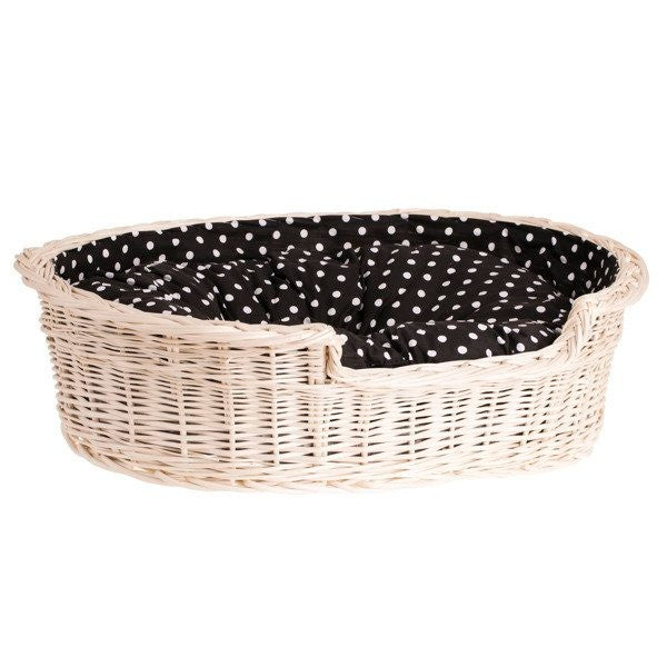 elegant whitewashed wicker dog bed in a bright nursery setting