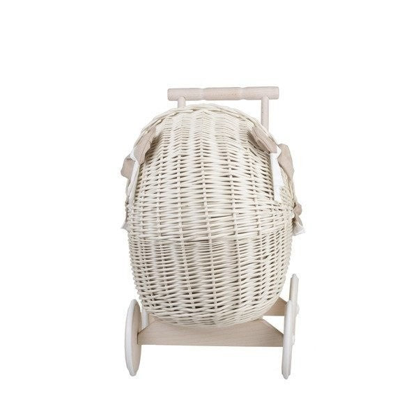 whitewashed wicker doll pram with beige bedding in a sunlit nursery setting