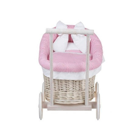 elegant whitewashed wicker doll pram with soft pink bedding in soft morning light